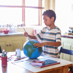 boy painting globe