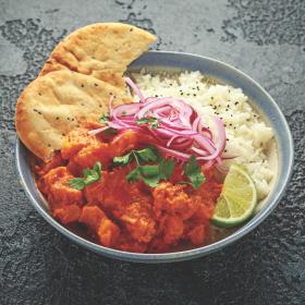 Indian fake-away with garnish, rice and bread